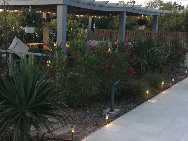 The garden pergola illuminated in the evening